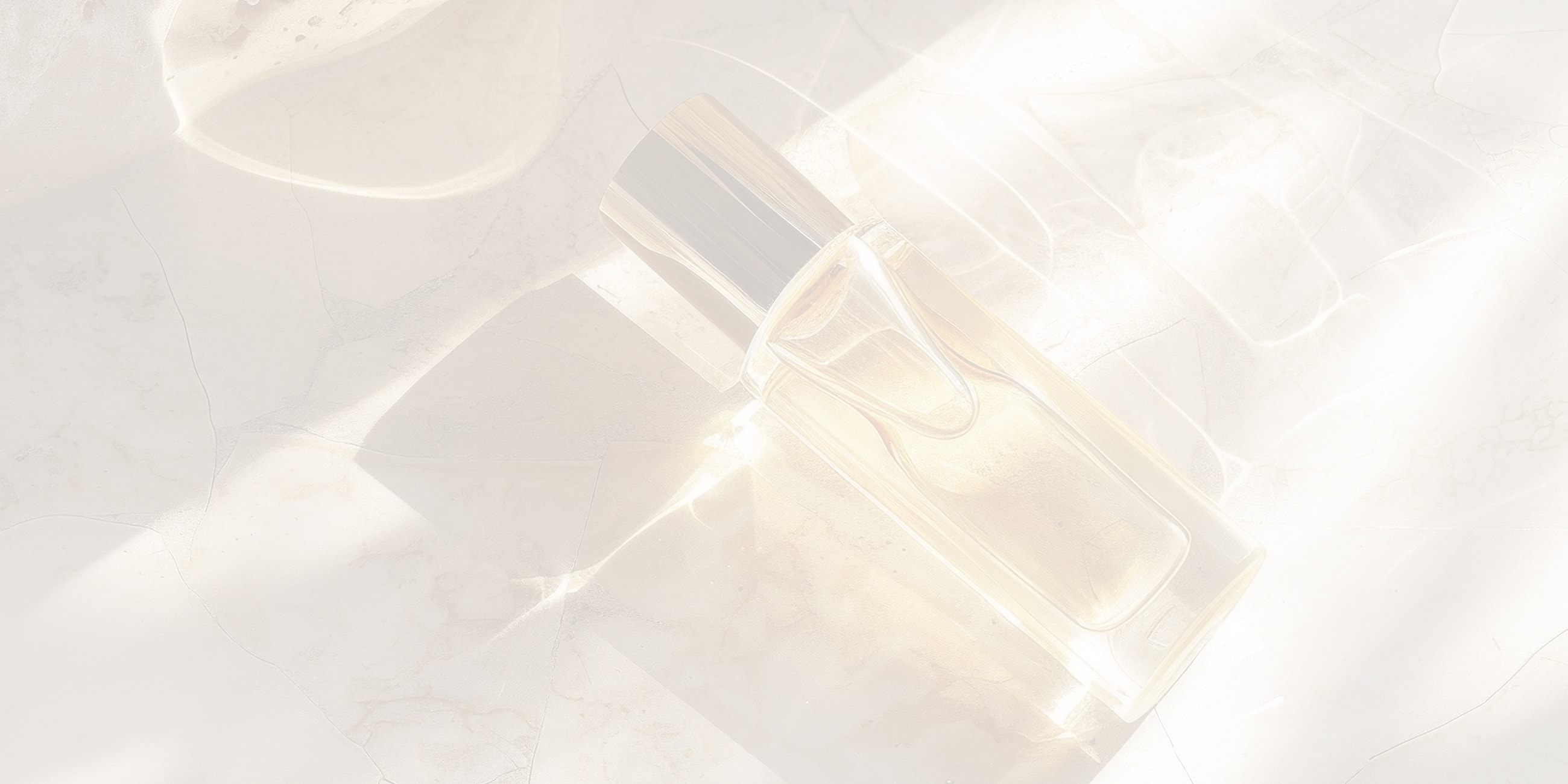 Perfume bottle on a light marble surface.