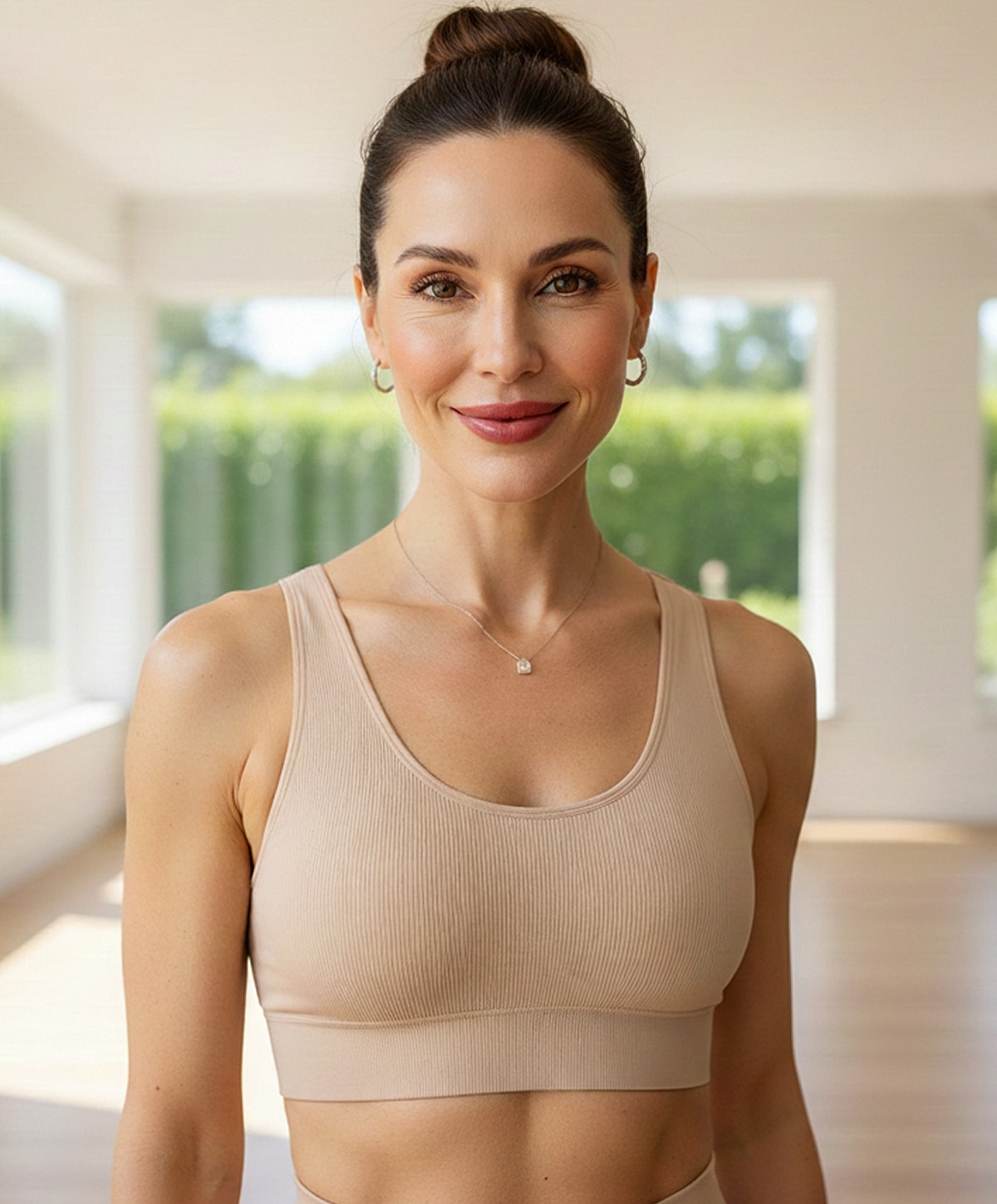 Smiling woman in workout attire indoors.