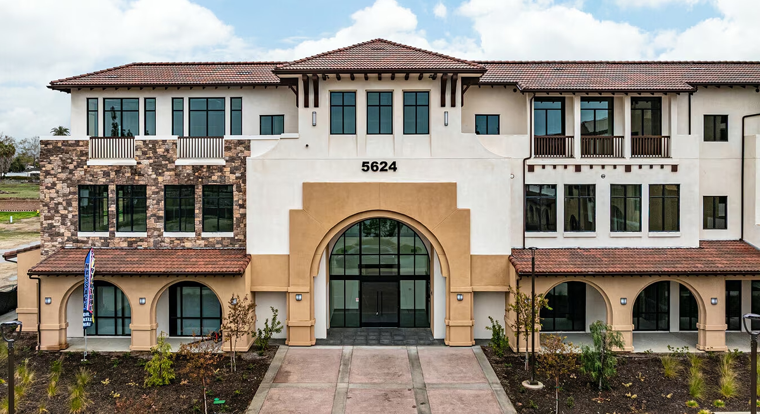 Modern building with architectural features and landscaping.